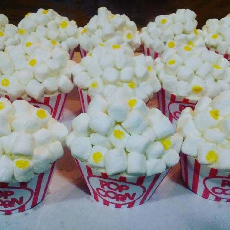 Cupcakes made to look like popcorn boxes, topped with marshmallows in striped wrappers