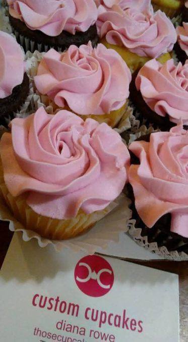 Cupcakes topped with pink buttercream piped into full rose swirls